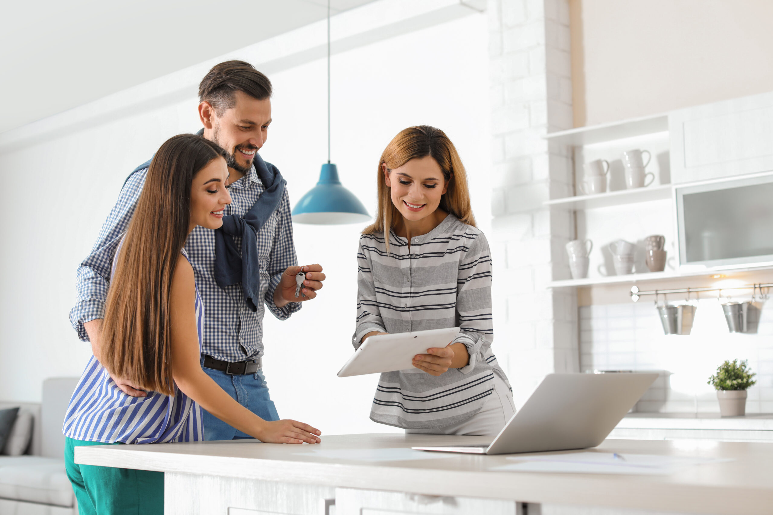 A couple and real estate agent discussing stamp duty